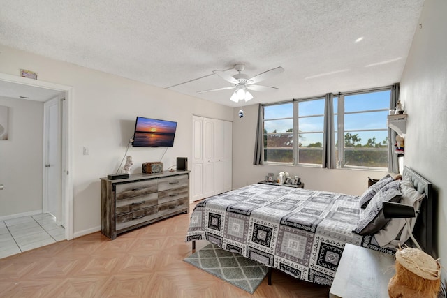 bedroom featuring a textured ceiling, a closet, and ceiling fan