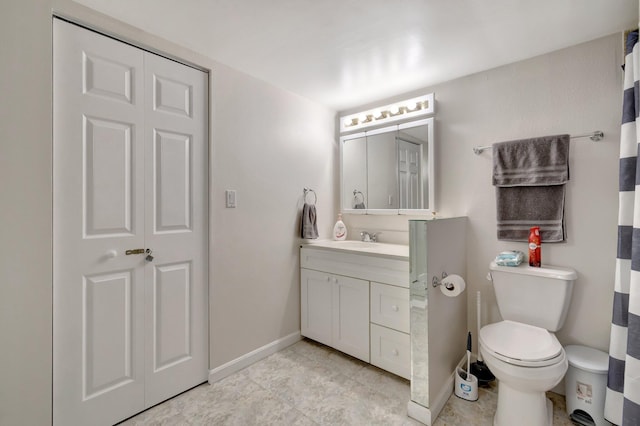 bathroom with tile patterned flooring, vanity, and toilet