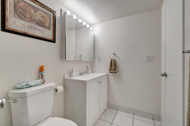 bathroom featuring tile patterned flooring, vanity, and toilet