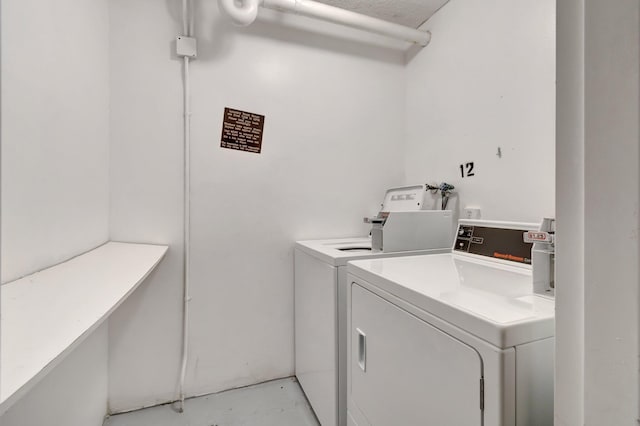 clothes washing area with separate washer and dryer