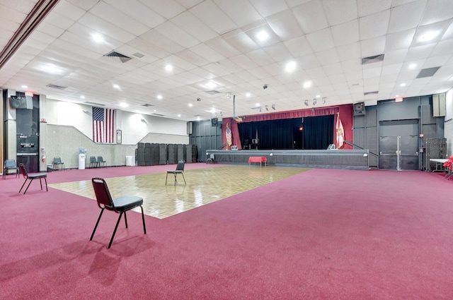 misc room featuring carpet flooring and a paneled ceiling