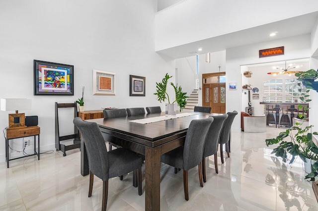 dining area with a high ceiling and an inviting chandelier