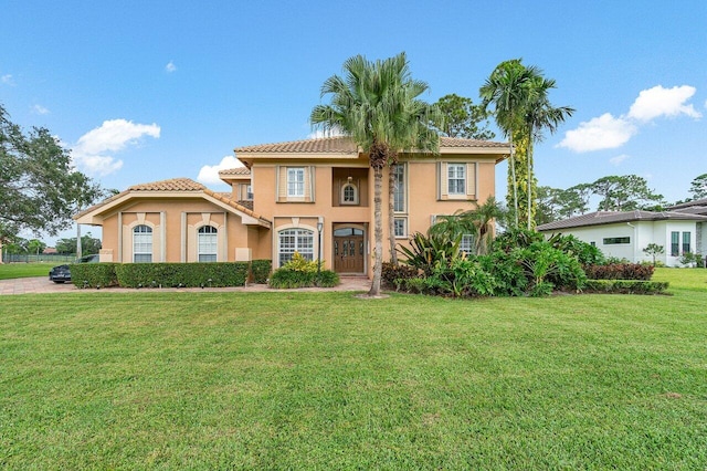 mediterranean / spanish home with a front yard