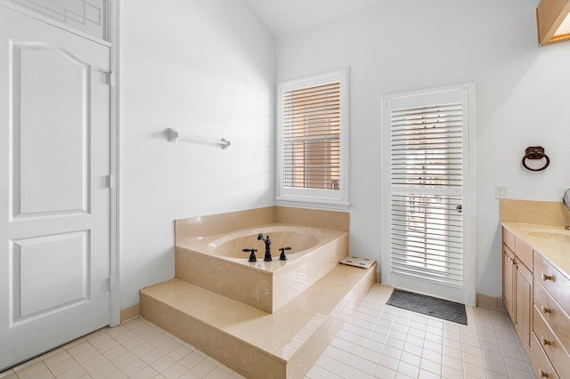 bathroom with a bathtub, vanity, and tile patterned floors