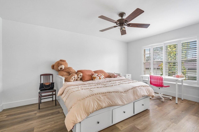 bedroom featuring hardwood / wood-style flooring and ceiling fan