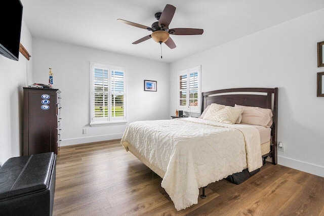 bedroom with ceiling fan and dark hardwood / wood-style flooring