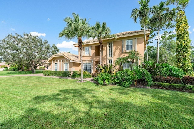 mediterranean / spanish-style home featuring a front lawn