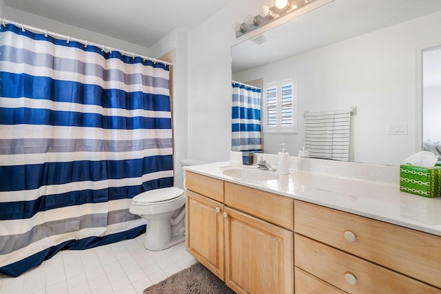 bathroom featuring tile patterned flooring, vanity, and toilet