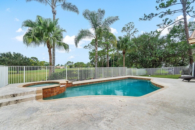 view of pool featuring a patio and an in ground hot tub