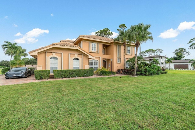 mediterranean / spanish house with a front lawn