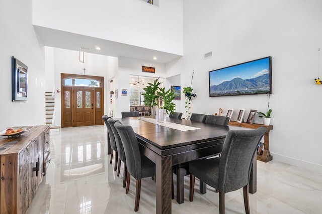 dining area with a towering ceiling