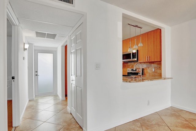 hallway with sink and light tile patterned floors