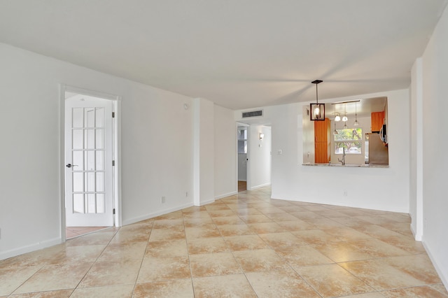 spare room featuring a notable chandelier