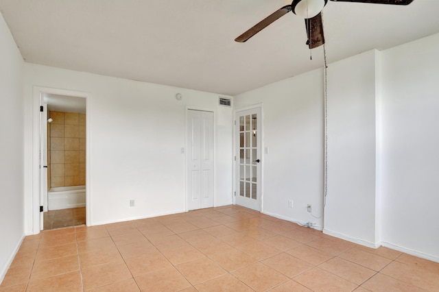 empty room with light tile patterned floors and ceiling fan