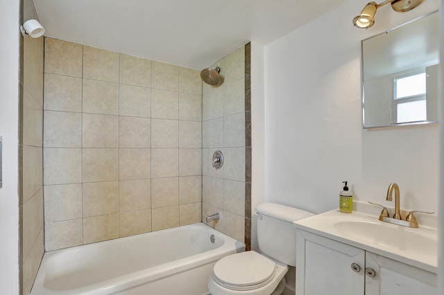 full bathroom featuring vanity, toilet, and tiled shower / bath combo