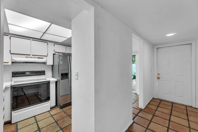 kitchen featuring white cabinetry, stainless steel refrigerator with ice dispenser, white electric stove, decorative backsplash, and light tile patterned floors