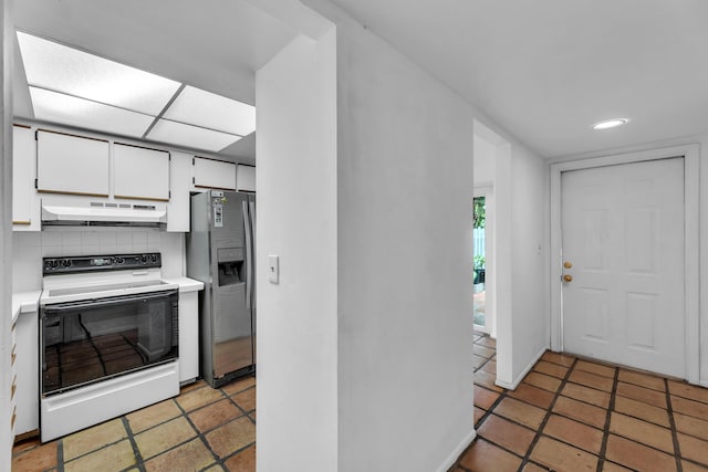 1912 NE 6th St, Deerfield Beach, FL 33441 - kitchen with white range with electric cooktop, under cabinet range hood, stainless steel fridge, light countertops, and tasteful backsplash