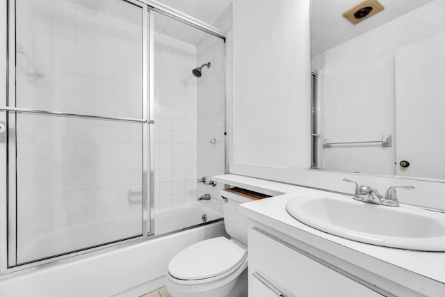 full bathroom with vanity, toilet, shower / bath combination with glass door, and a textured ceiling