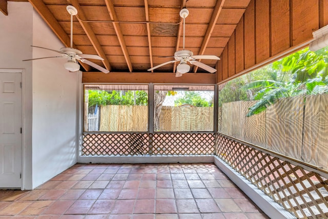 unfurnished sunroom with ceiling fan and lofted ceiling