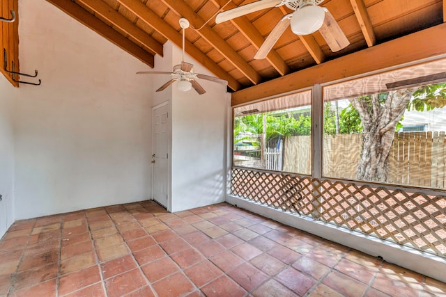 unfurnished sunroom with vaulted ceiling with beams, ceiling fan, and wooden ceiling