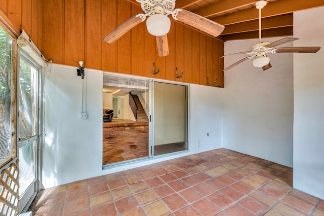 unfurnished sunroom featuring beamed ceiling