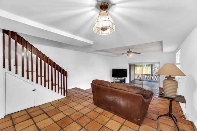 living room featuring tile patterned floors and ceiling fan