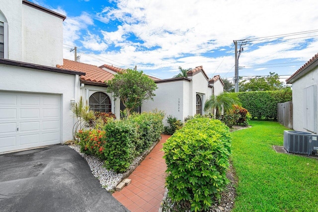 exterior space featuring cooling unit and a yard