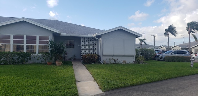 ranch-style home with a front lawn