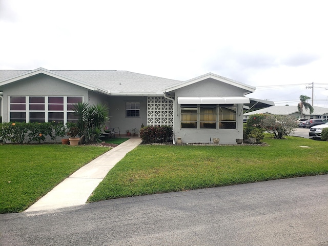 view of front of house with a front lawn and stucco siding