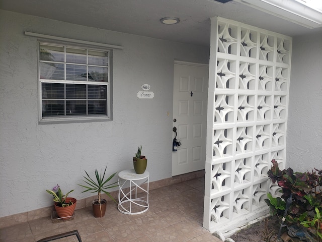 doorway to property with stucco siding