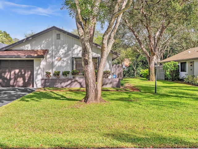 exterior space featuring a garage and a front yard