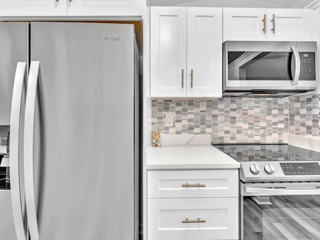 kitchen featuring white cabinetry, backsplash, and stainless steel appliances