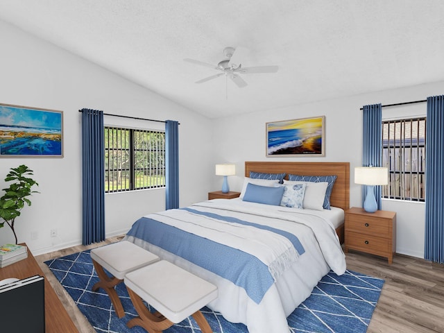 bedroom featuring wood-type flooring, vaulted ceiling, and ceiling fan