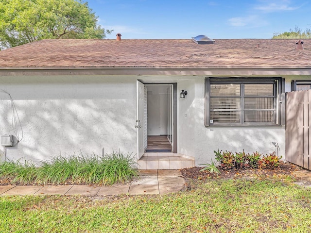 entrance to property with a lawn