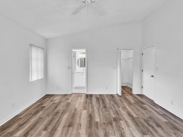 spare room featuring hardwood / wood-style floors, ceiling fan, and lofted ceiling