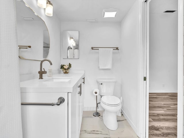 bathroom featuring hardwood / wood-style flooring, sink, and toilet