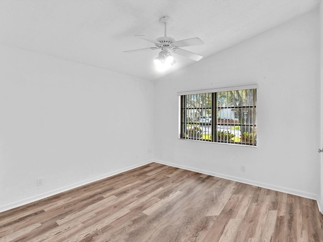 unfurnished room with ceiling fan, light hardwood / wood-style flooring, and vaulted ceiling