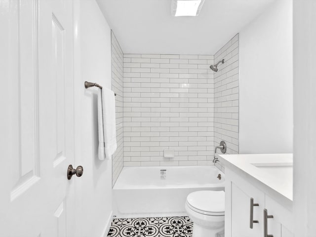 full bathroom featuring tile patterned floors, vanity, toilet, and tiled shower / bath combo