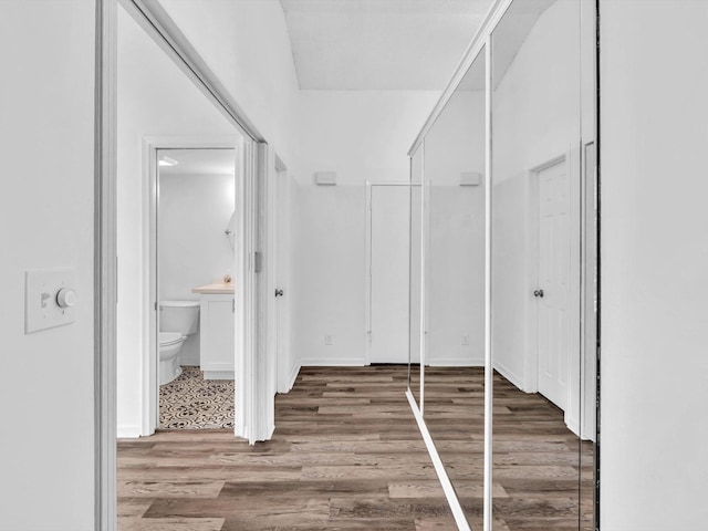 bathroom featuring wood-type flooring and toilet