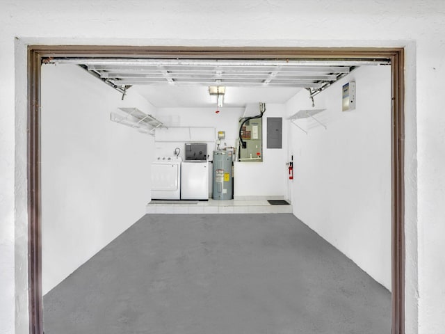 garage featuring electric panel, separate washer and dryer, and water heater