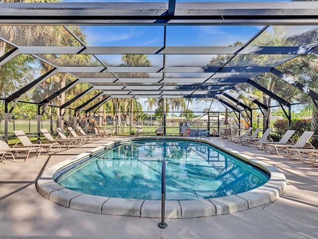 view of swimming pool with a lanai and a patio area