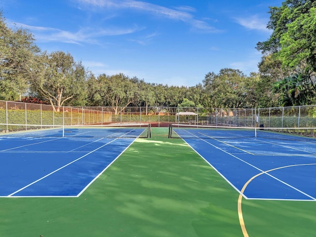 view of tennis court with basketball hoop