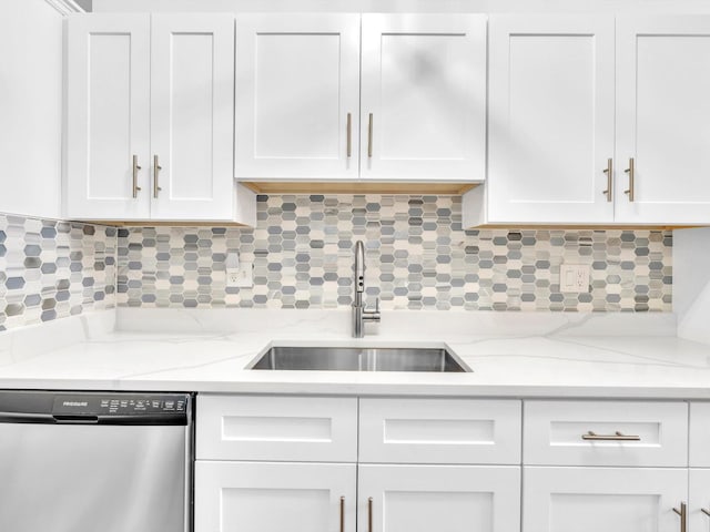 kitchen featuring white cabinetry, sink, dishwasher, and tasteful backsplash