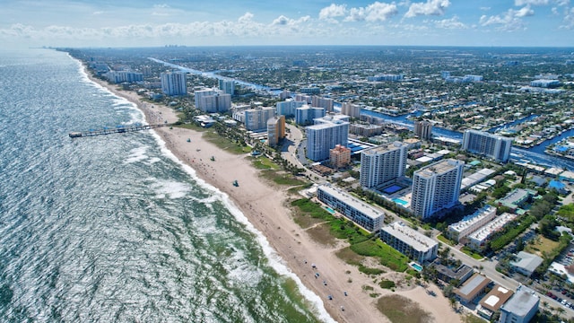 drone / aerial view featuring a view of the beach and a water view