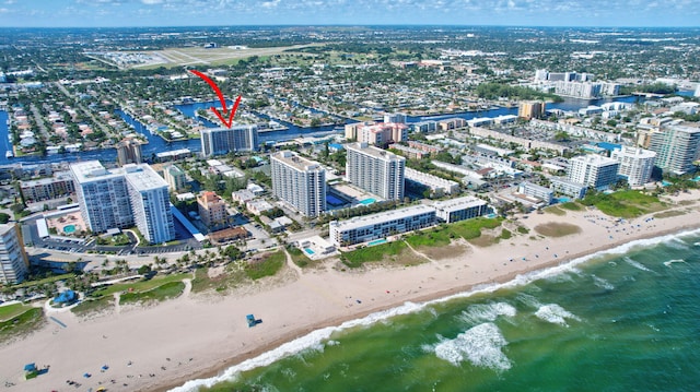 bird's eye view featuring a beach view and a water view