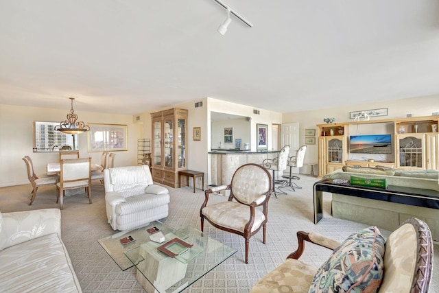 carpeted living room with rail lighting