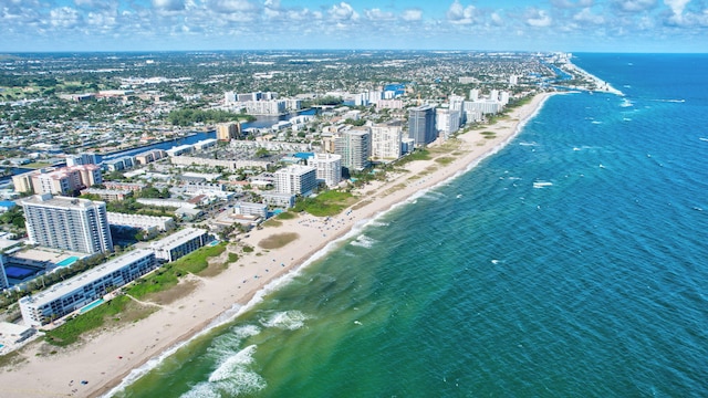 birds eye view of property featuring a view of the beach and a water view