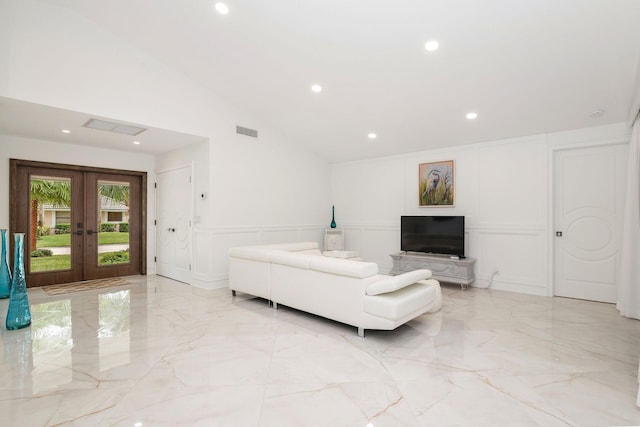 living room with high vaulted ceiling and french doors