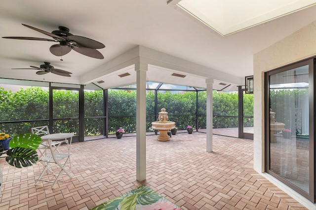 unfurnished sunroom with ceiling fan