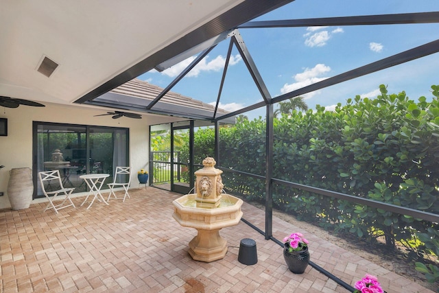 sunroom featuring ceiling fan